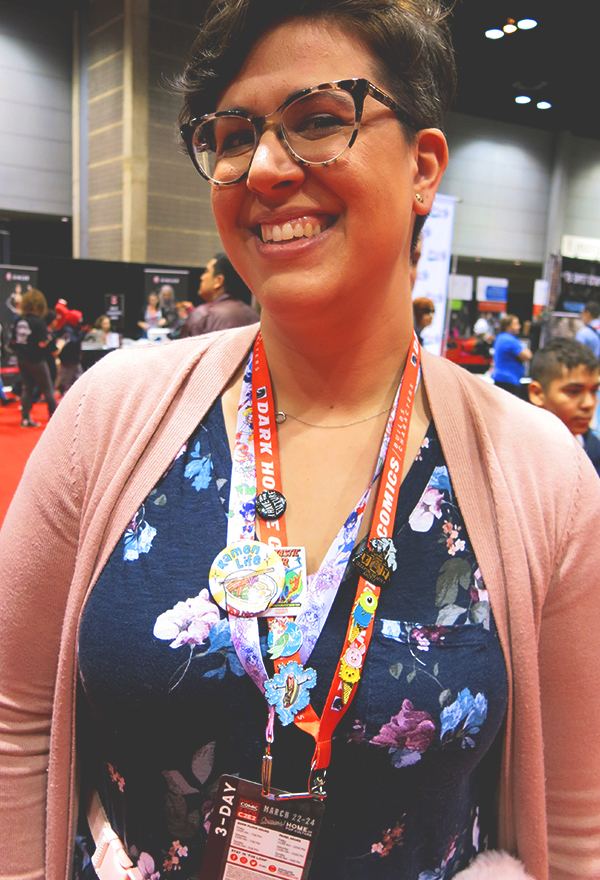 woman wearing comic con buttons on lanyard