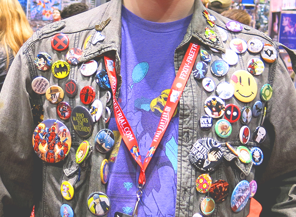 man wearing comic con buttons on jacket