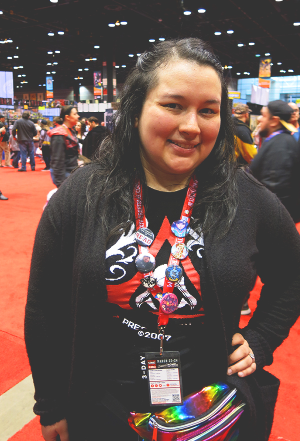 woman wearing comic con buttons on lanyard