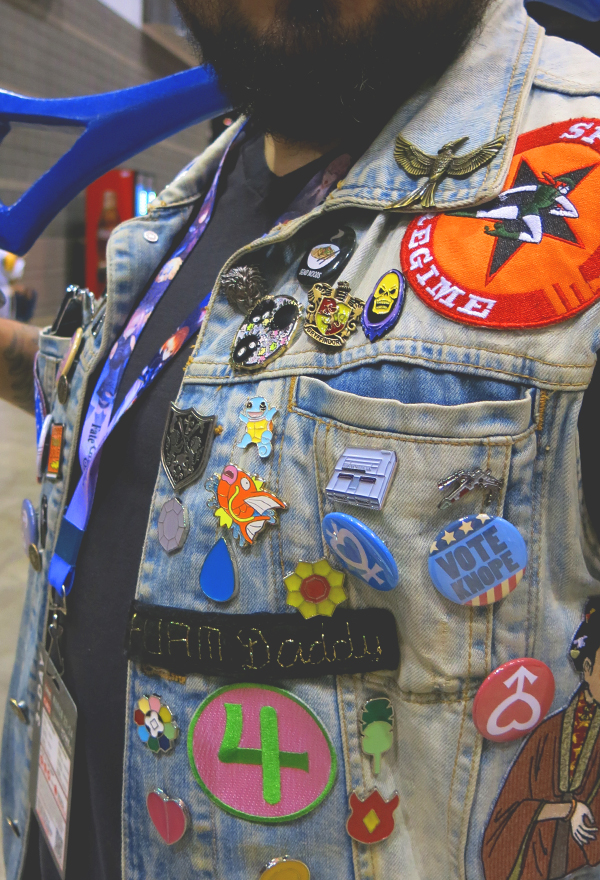 woman wearing comic con buttons on lanyard